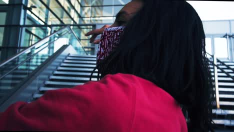 Female-dancer-in-red-and-wearing-a-face-mask-dancing-in-slow-motion-making-eye-contact-with-camera-during-covid-19-stay-at-home-orders