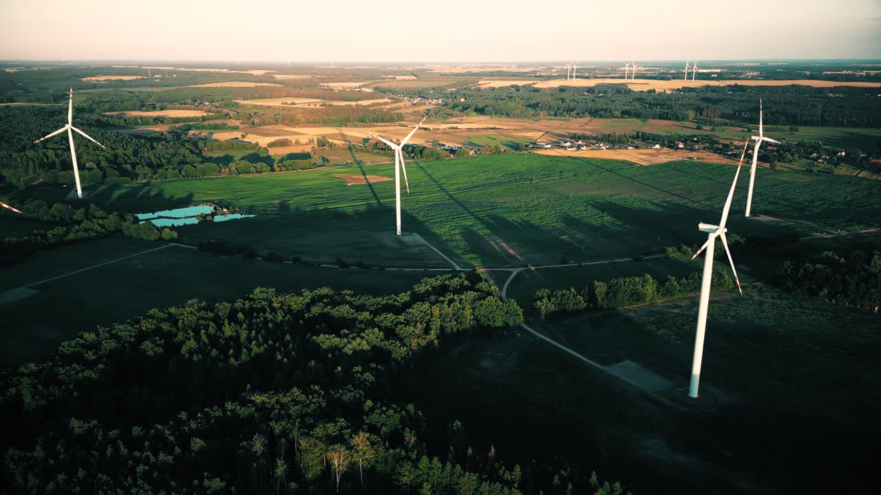 Aerial view of windmills farm for energy production on beautiful cloudy sky at highland