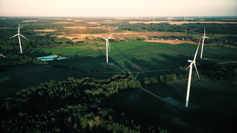 aerial view of windmills farm for energy production on beautiful cloudy sky at highland