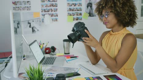 young woman exploring photos on camera