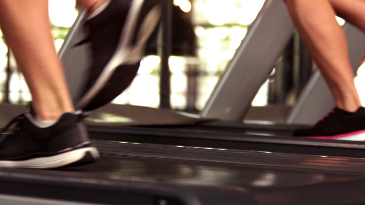 Fit people running on treadmills