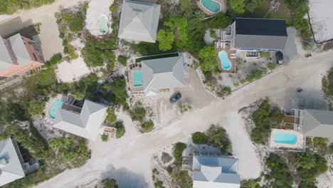 Eagle-eye-aerial-above-condos-on-white-sandy-beach-roads-in-Cape-San-Blas,-Florida