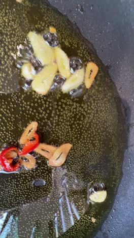 cooking garlic and red peppers in a pan