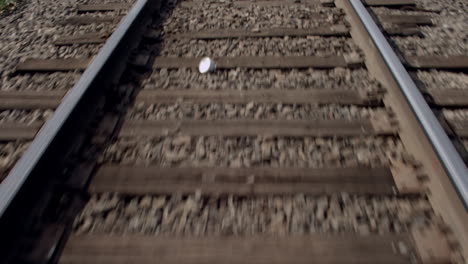 point of view of a train moving over railroad tracks alongside the country