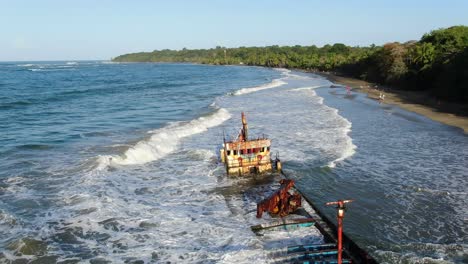 Costa-Rica-beach-drone-view-showing-sea,-shore-and-a-stranded-ship