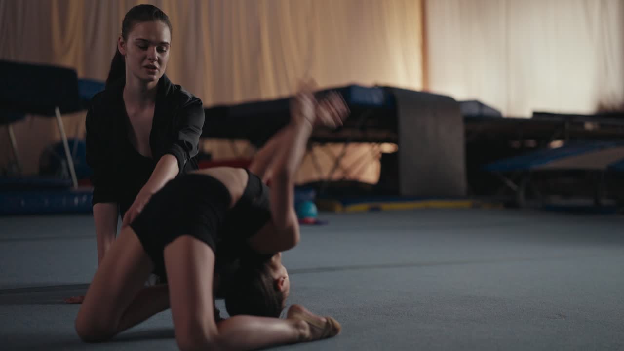 Young gymnast training with a coach