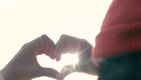 unknown girl with the red hoody forming a heart