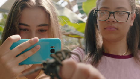 teenage girls playing with tarantula spider friends taking photos using smartphone sharing zoo excursion on social media having fun learning about arachnids at wildlife sanctuary 4k