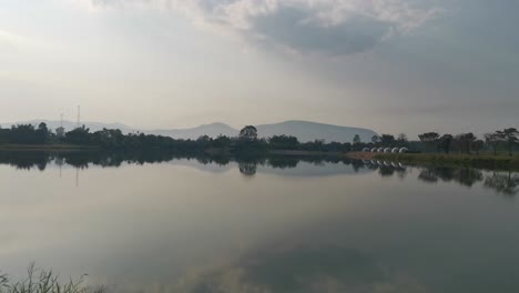 a pristine, still lake showcases crystal clarity and reflects the beauty of its surrounding landscape in thailand