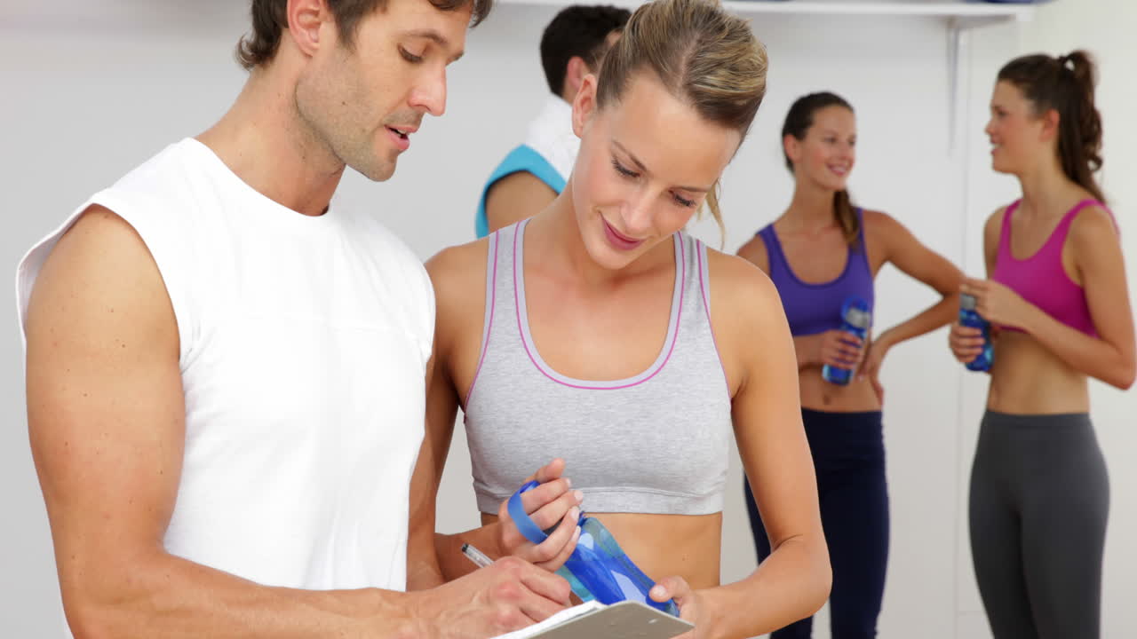 에어로빅 강사가 금발과 얘기하고 있어요.