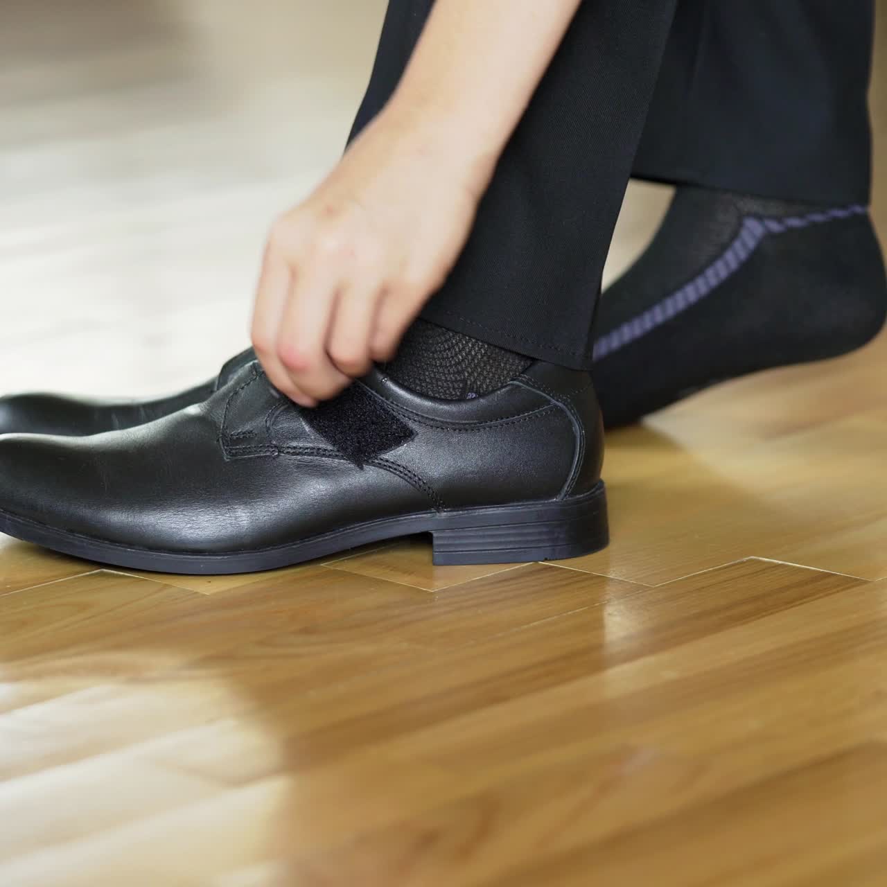 Boy put on ones shoes