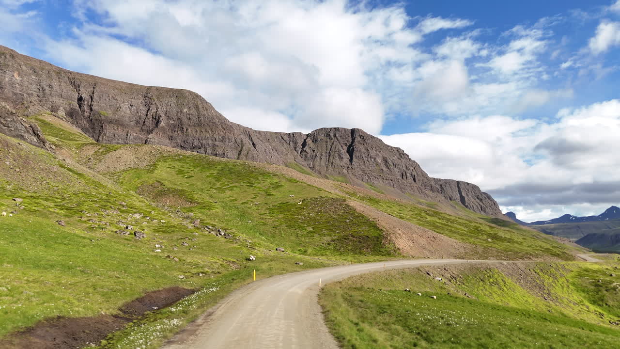 Aerial view of Hvammsfjörður in Vesturland Iceland on a colorful sunny day, showing vibrant waters, surrounding landscape, and clear blue sky from above