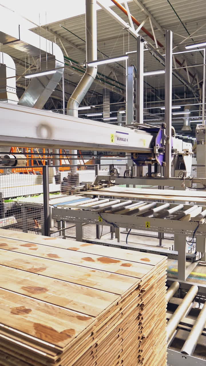 Modern equipment for automating wood processing at the factory. Making parquet with the help of robotic technology and people. Vertical video