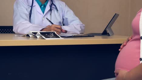 pregnant woman and gynecologist doctor at hospital