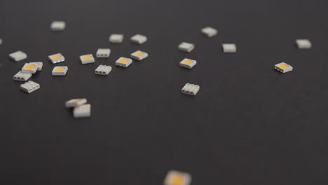 dropping small electronic components on black background-1