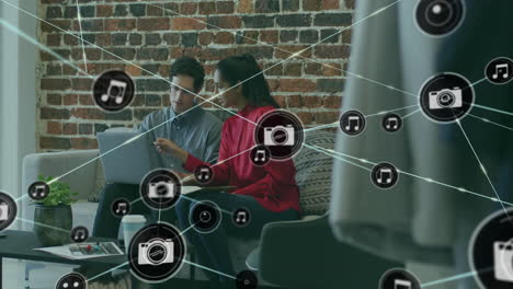 animation of network of connections with camera icons over diverse business people in office