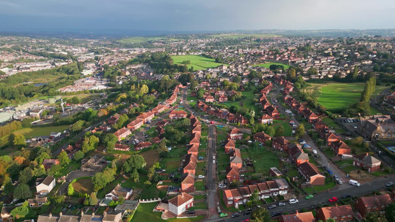 Yorkshire's urban living: Red brick council estate, aerial drone footage, morning sun, bustling streets, and residential charm