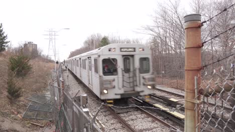 Cinematic-Ground-View-of-Metropolitan-Train-during-an-overcast-winter-day