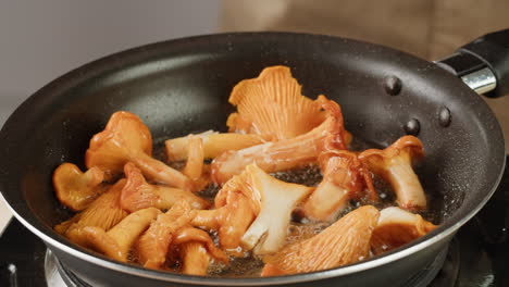 frying chanterelle mushrooms in a pan