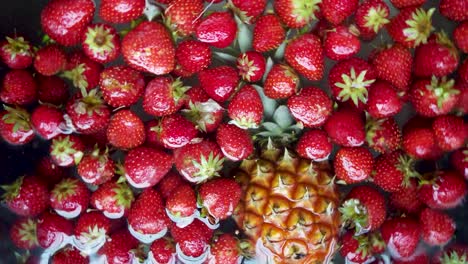 Fresh-whole-fruit-in-water-spinning-in-circle,-vertical-background