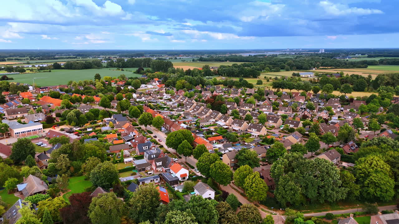 Numerous similar houses in the panorama of lovely town. Drone footage over the scenery of the Netherlands on cloudy day