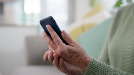 Cellphone,-hands-and-senior-woman-on-a-sofa-scroll