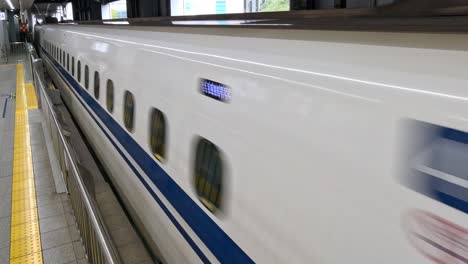 a high-speed train arriving at and leaving a station