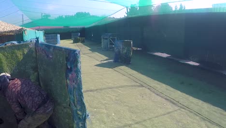 girls and boys playing paintball in an outdoor arena