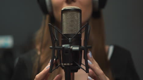 talented woman records new song in studio focus on mic