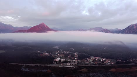 aerial - low clouds above the mountain village at lake skadar, montenegro, pan left