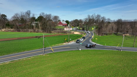 amish horse and buggy travel through rural lancaster county pa during spring