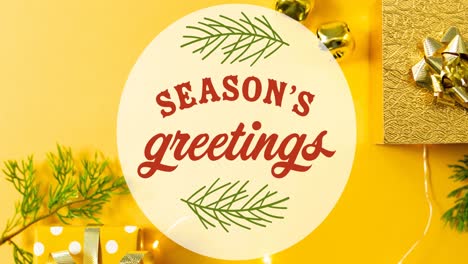 animation of seasons greetings in circle over christmas decorations on yellow background