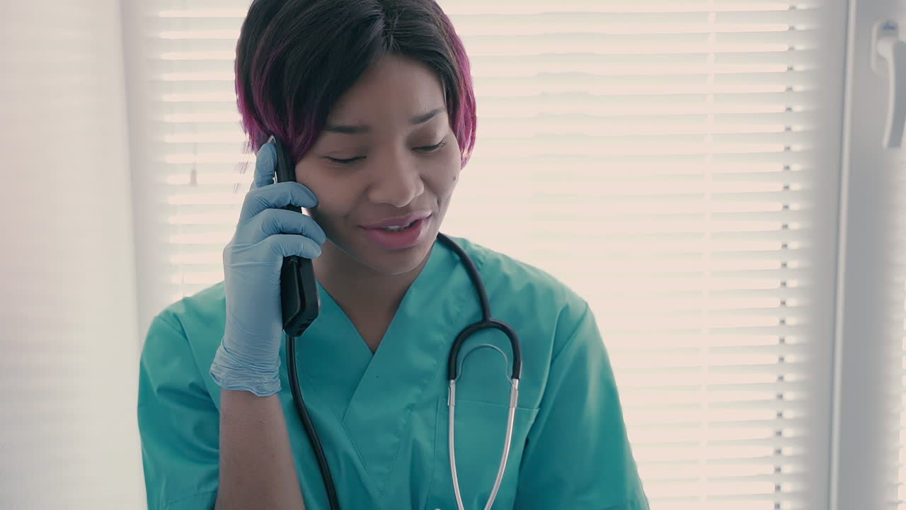 A Beautiful Young Female Nurse Talking On The Cellphone