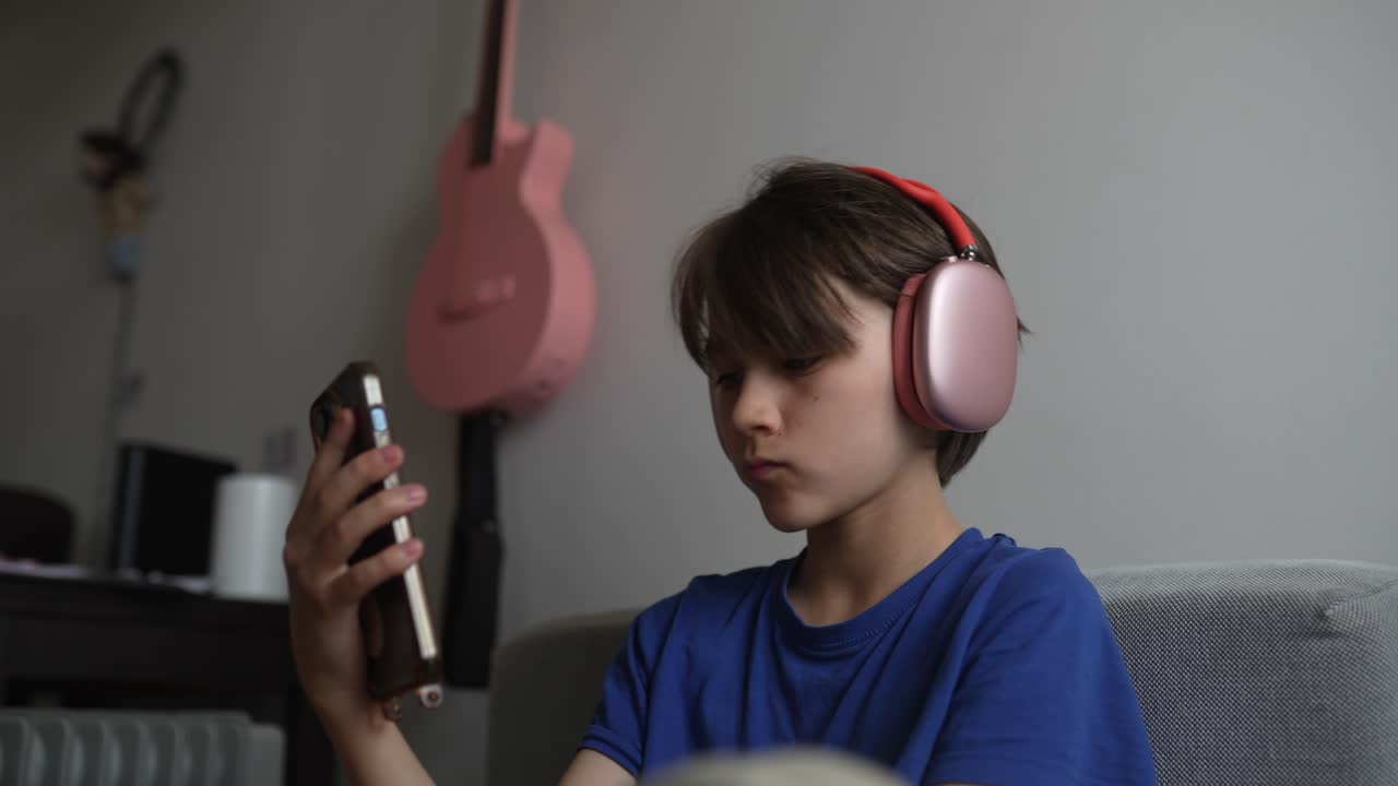 Teenage boy using smartphone with headphones