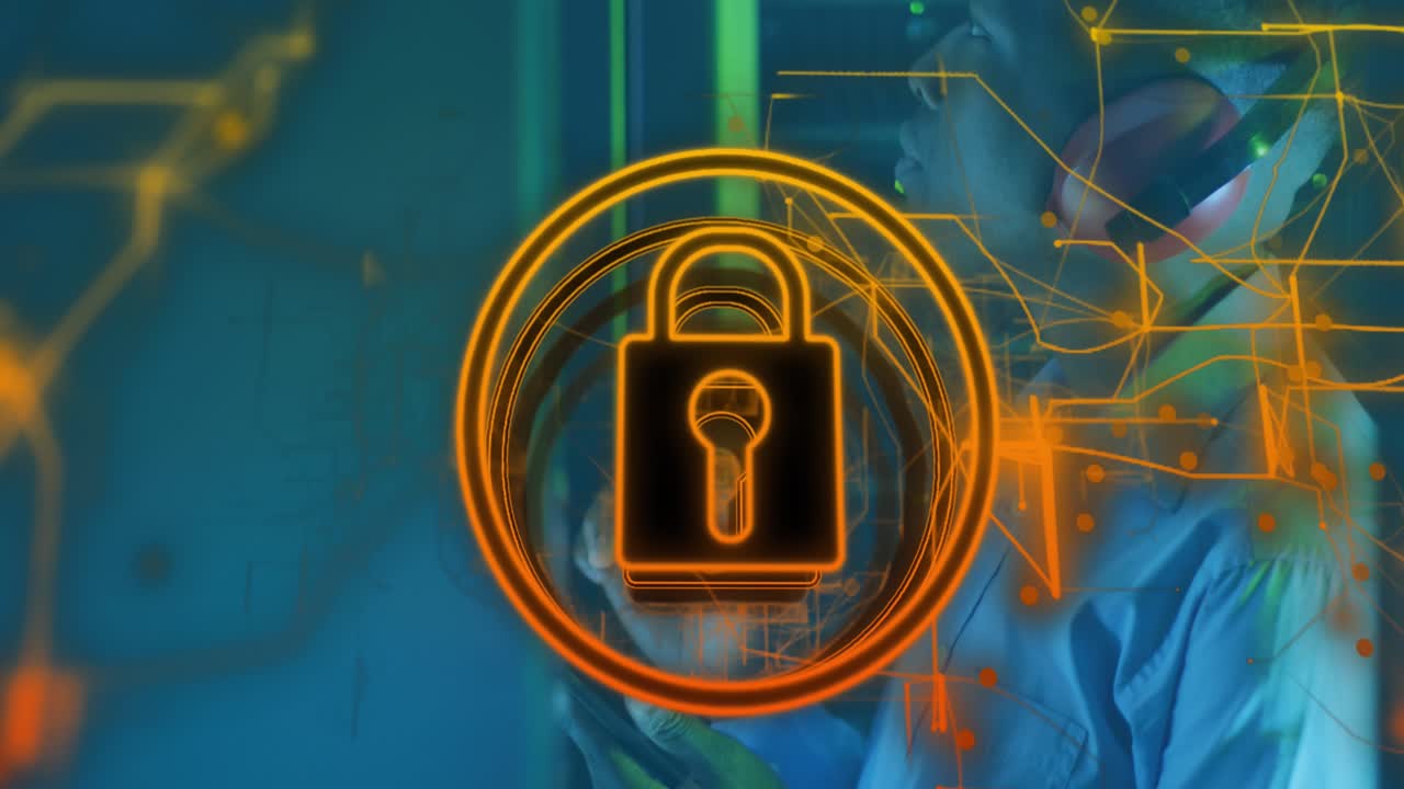 Animation of icon padlock data processing over african american it man by computer servers