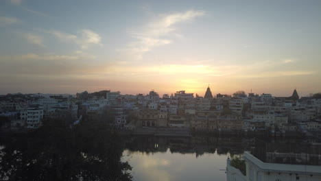 a beautiful sunset hyperlapse of a city in india with a large canal running through.