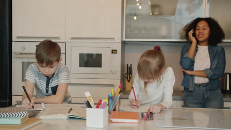 children doing homework in a kitchen