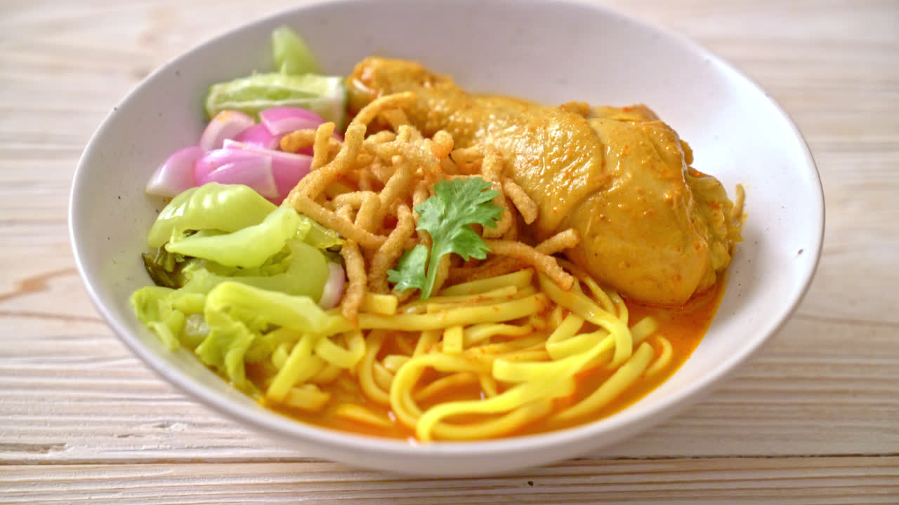 Northern Thai noodle curry soup with chicken (Kao Soi Kai) - Thai food style