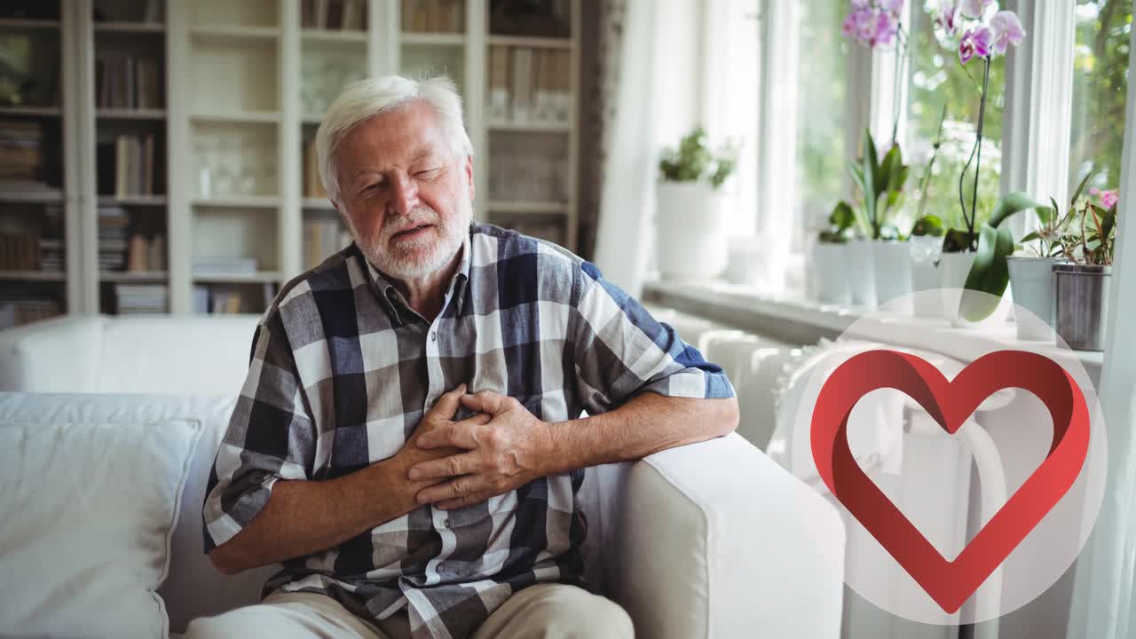Animation of heart icon over senior caucasian man touching his chest