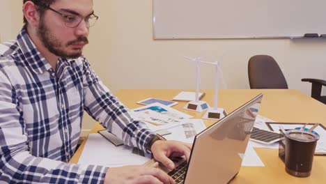 close-up of engineer's hands typing on laptop keyboard