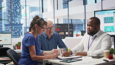 middle aged couple explores life insurance contract terms with financial adviser