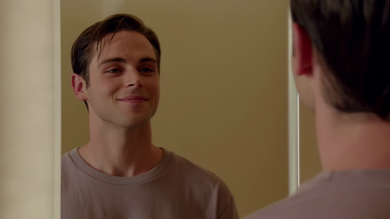 Young Man Looking At Mirror In Small Bathroom Practicing Confident Smile, Morning Routine, Soft Warm Lighting,