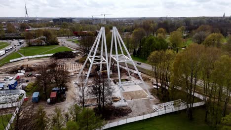 Auf-Einem-Feld-Wird-Eine-Große-Weiße-Panorama-Rad-Struktur-Errichtet