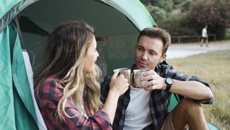 couple of travelers celebrating vacation at campsite