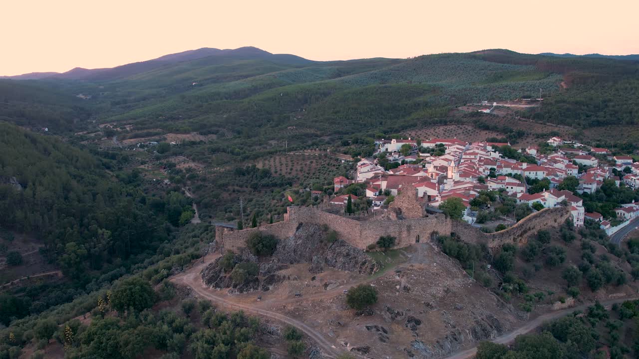 Aerial fly over Alegrete,a historic village near Portalegre, with its medieval castle,cobblestone streets,whitewashed Alentejo houses,and 16th-century church,nestled in the scenic Serra de São Mamede.