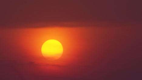 a stunning sunset over battambang in cambodia, with clouds and smoky haze in the gold and orange sky