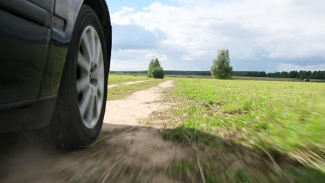 lose up the wheel of a car moving across the field.