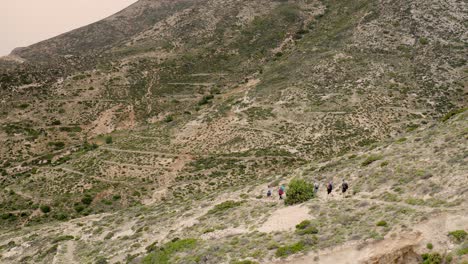 Tourists-are-walking,-do-trekking-along-a-mountain-trail-in-the-high-mountains-of-Greece