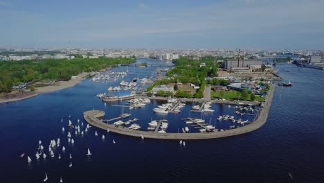 yachts port in a city bay, summer sun, white ripples on a water