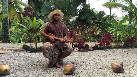 pacific islander man plays on ukulele guitar